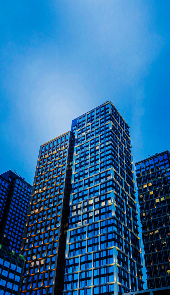 Dawn view of urban townhouse with matte facade, illuminated windows, and subtle la noir’e Da Vinci mood grade.